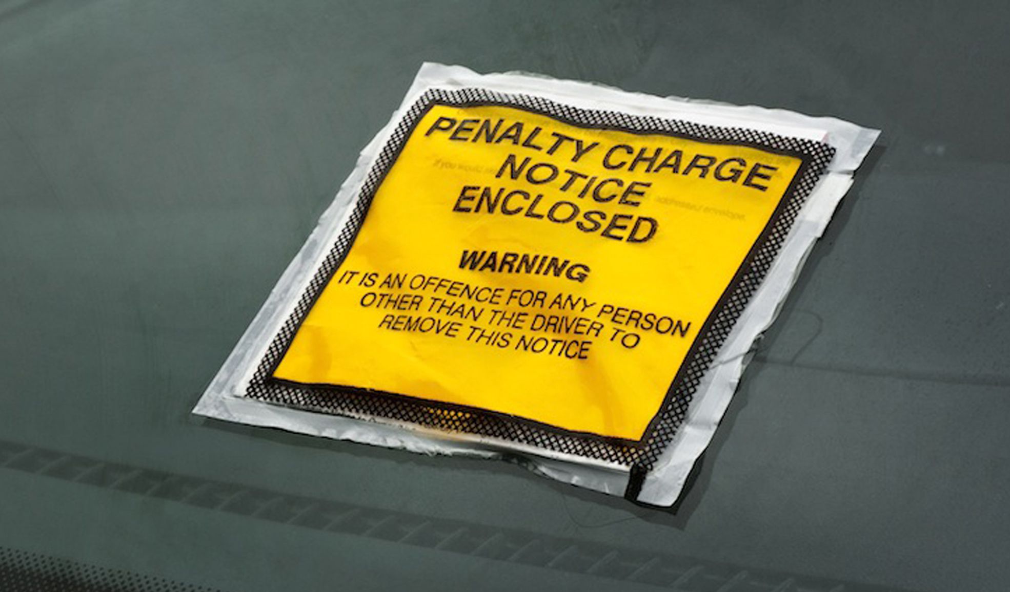 Yellow penalty charge notice on a windscreen