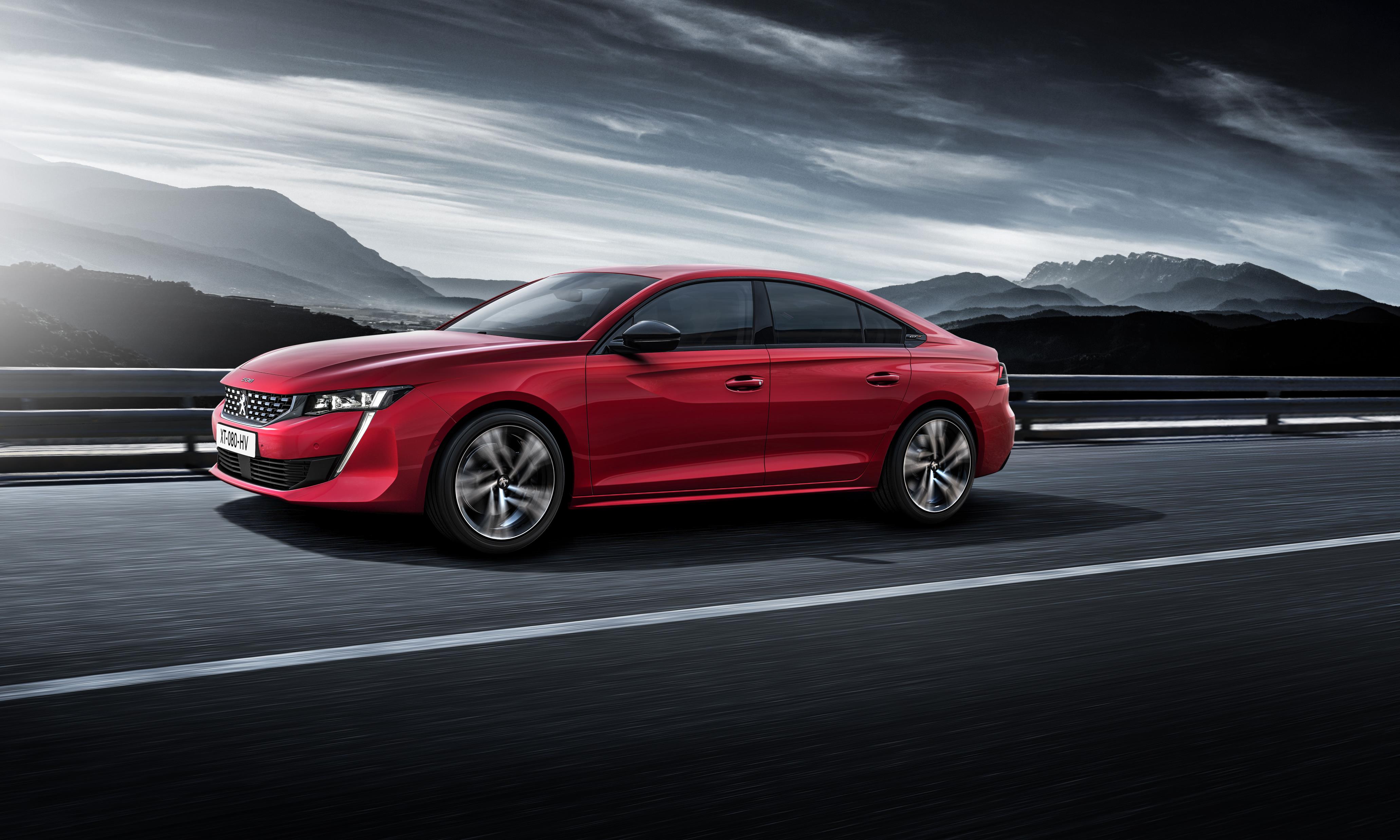 Red Peugeot 508 with dramatic backdrop