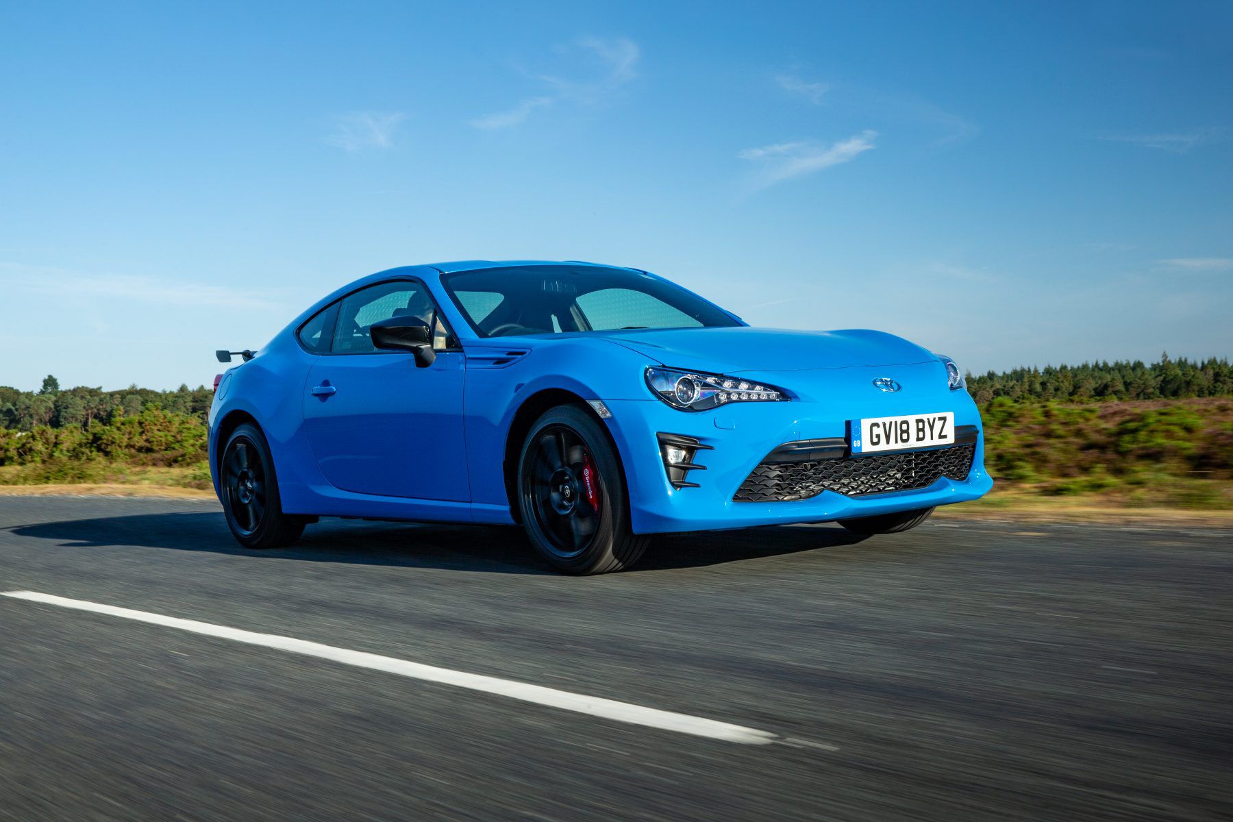 Front view of a blue GT86-Blue-Edition-Dynamic-7 driving down the road