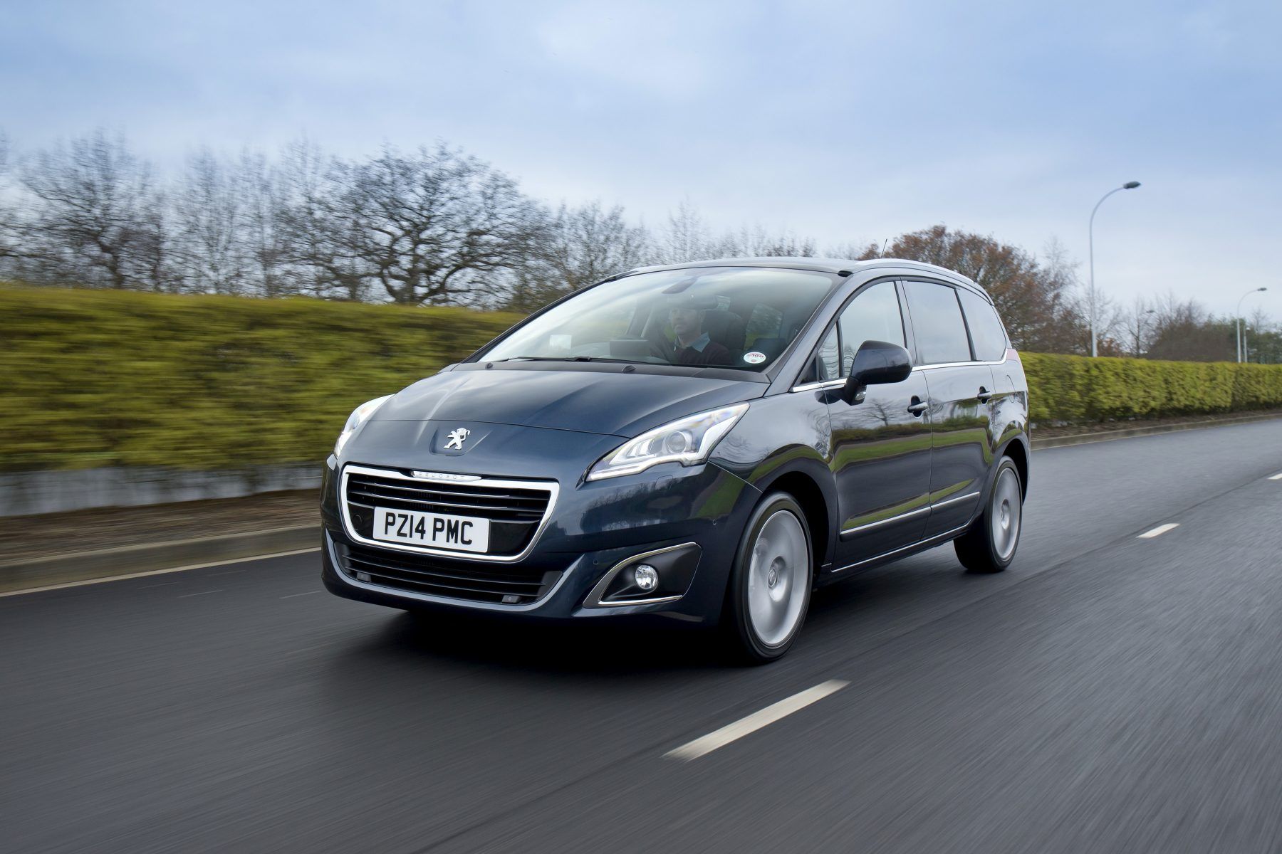 peugeot 5008 driving down the road