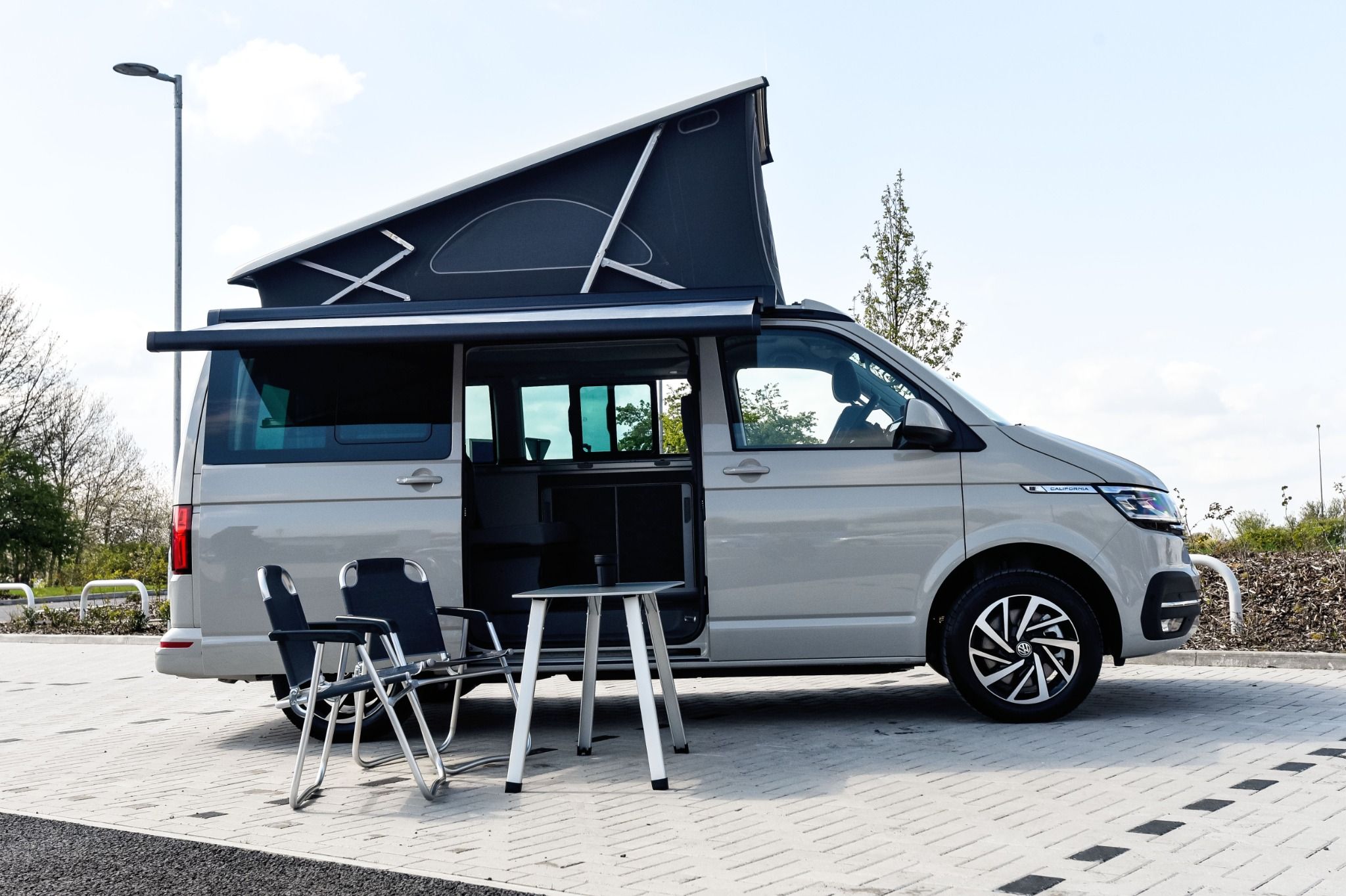 Volkswagen California Ocean Roof extended with camping set outside